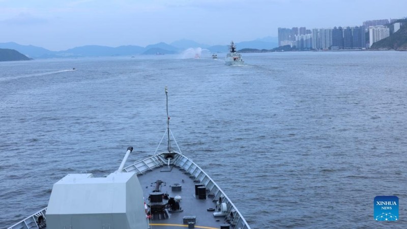 Ένα πυροσβεστικό σκάφος της κυβέρνησης της Ειδικής Διοικητικής Περιοχής του Χονγκ Κονγκ πραγματοποιεί τελετή υποδοχής για τον στόλο του Ναυτικού του Λαϊκού Απελευθερωτικού Στρατού της Κίνας στο Χονγκ Κονγκ, της νότιας Κίνας, στις 3 Ιουλίου του 2025. 