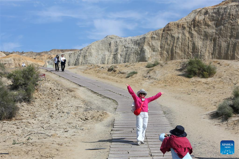 Τουρίστας ποζάρει για φωτογραφίες σε ένα γραφικό σημείο της Λίμνης Ουλουνγκούρ (Ulunggur) στην κομητεία Φουχάι της διοικητική περιφέρεια Αλτάι, στην Αυτόνομη Περιοχή των Ουιγούρων της επαρχίας Σιντζιάνγκ, στις 8 Σεπτεμβρίου του 2025. (Φωτογραφία / Xinhua)